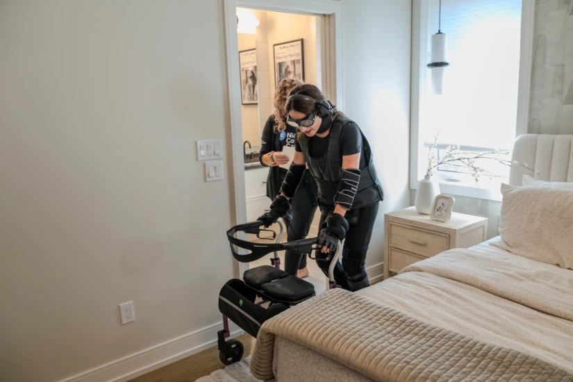 A participant wears an aging suit that simulates sarcopenia, the age-related loss of muscle.