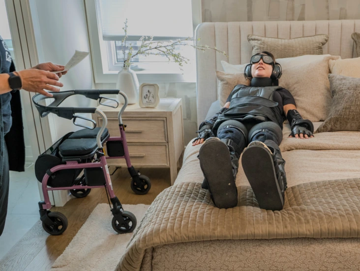 A participant gets out of bed while wearing an aging suit, one of the everyday tasks in the study.